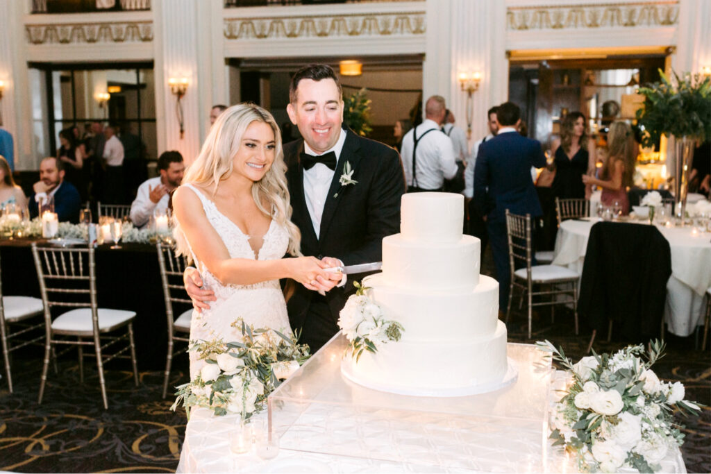 Bride & groom cutting their wedding cake at their Cescaphe wedding reception