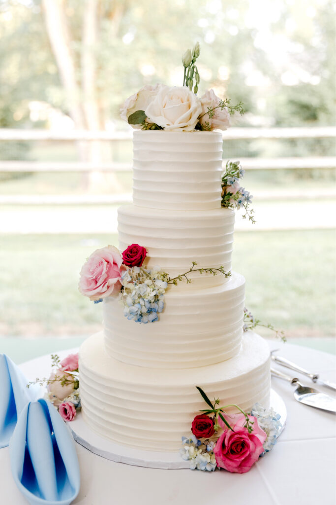 four tier wedding cake with vibrant summer florals