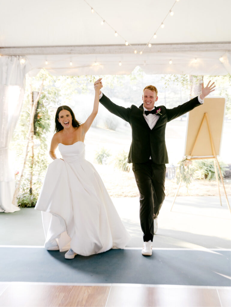 bride & groom entering their white tented Pennsylvania wedding ceremony