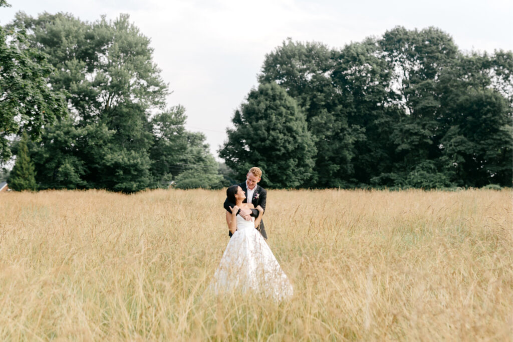 bride and groom in Pennsylvania field by Emily Wren Photography