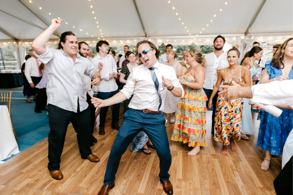 guests dancing during white tent wedding reception by Emily Wren Photography