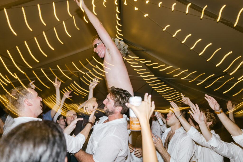 guests having fun during white tent & twinkle lights wedding reception by Pennsylvania wedding photographer Emily Wren Photography