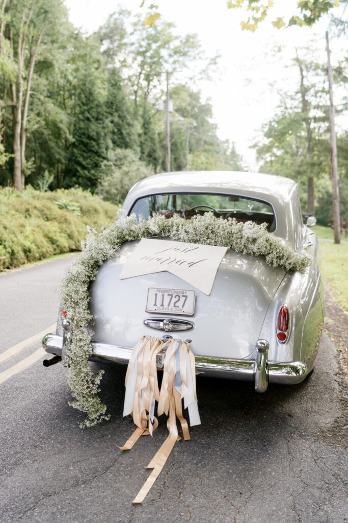 vintage Rolls Royce decorated for wedding with "Just Married" sign by Emily Wren Photography