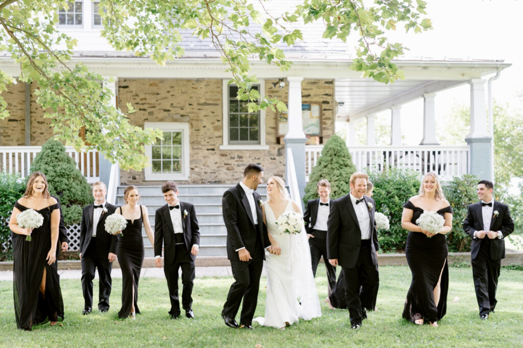 full wedding party in all black outfits at Lakeside summer wedding by Emily Wren Photography