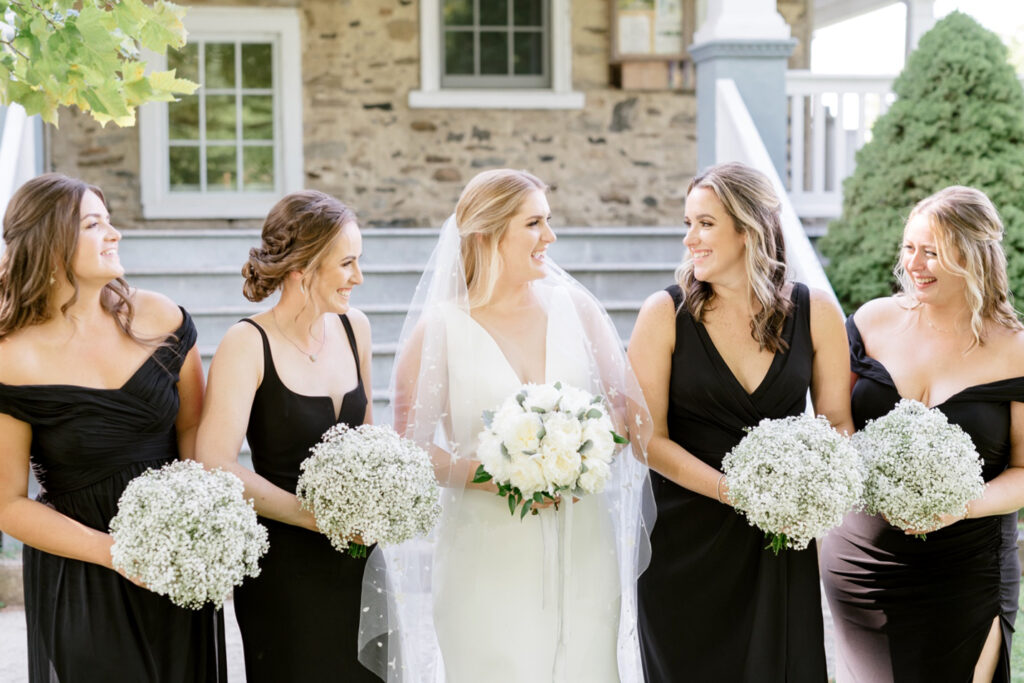 bride with bridesmaids in black bridesmaid dresses