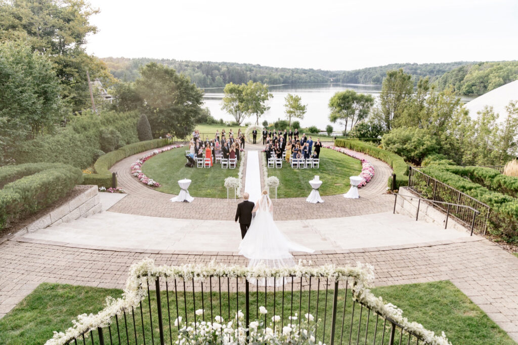 bride walking down the aisle at elegant lakeside wedding ceremony by Pennsylvania wedding photographer Emily Wren Photography