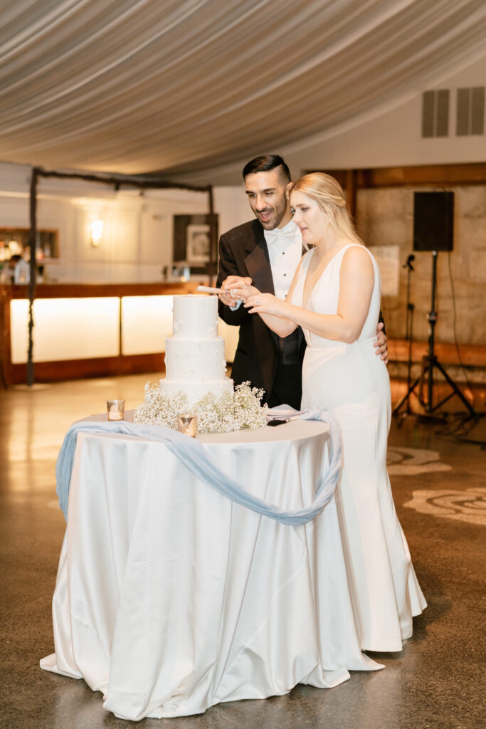 bride & groom cutting their 3 tier wedding cake