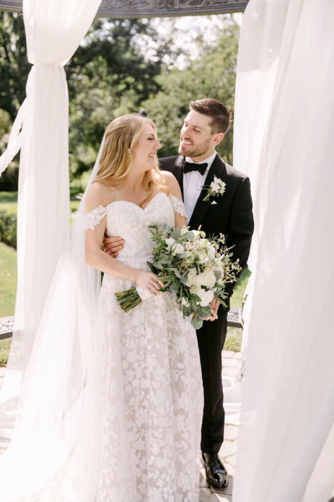 bride and groom under white linen gazebo tent at the Inn at Barley Sheaf