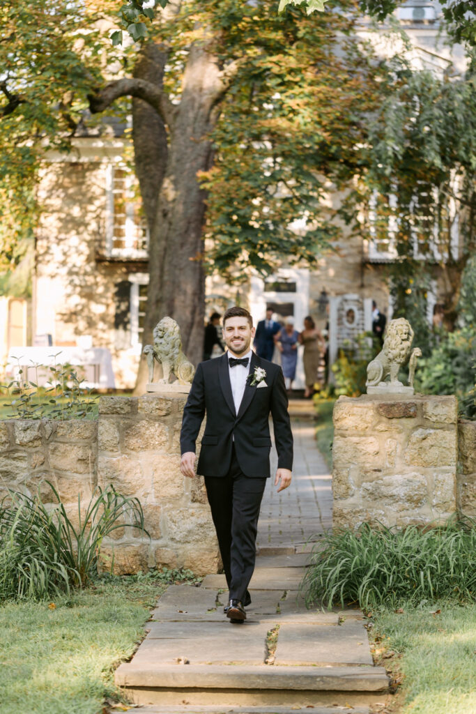 groom walking down the aisle at outdoor wedding ceremony