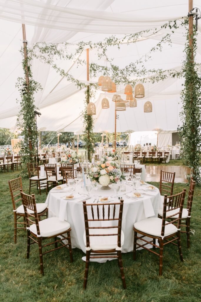 whimsical outdoor garden wedding reception under a white linen tent