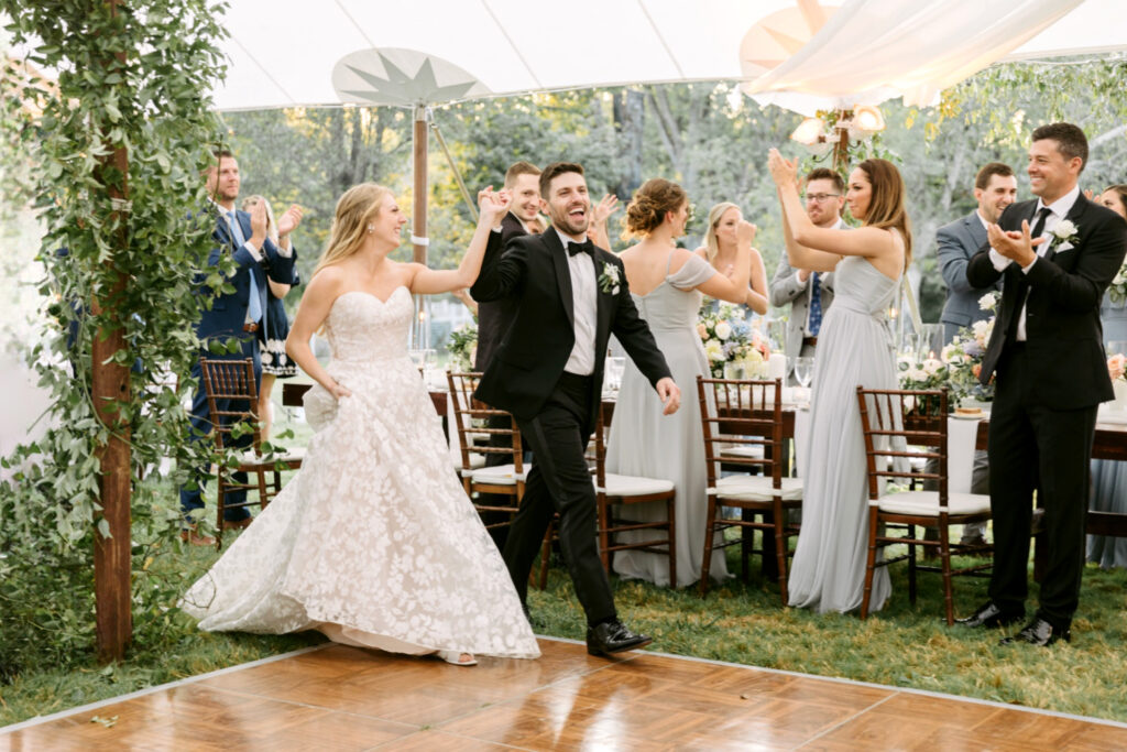 bride & groom entering their outdoor wedding reception