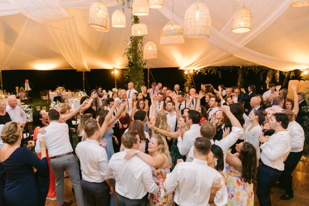 guests dancing and partying at outdoor white tented wedding reception by Emily Wren Photography