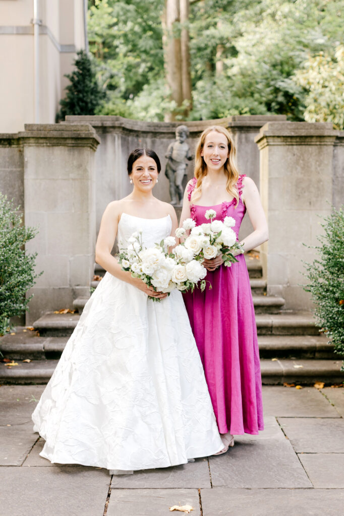 bride with maid of honor in hot pink bridesmaids dress