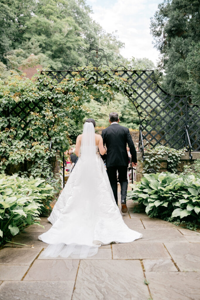 bride entering outdoor garden wedding ceremony at Winterthur Musuem