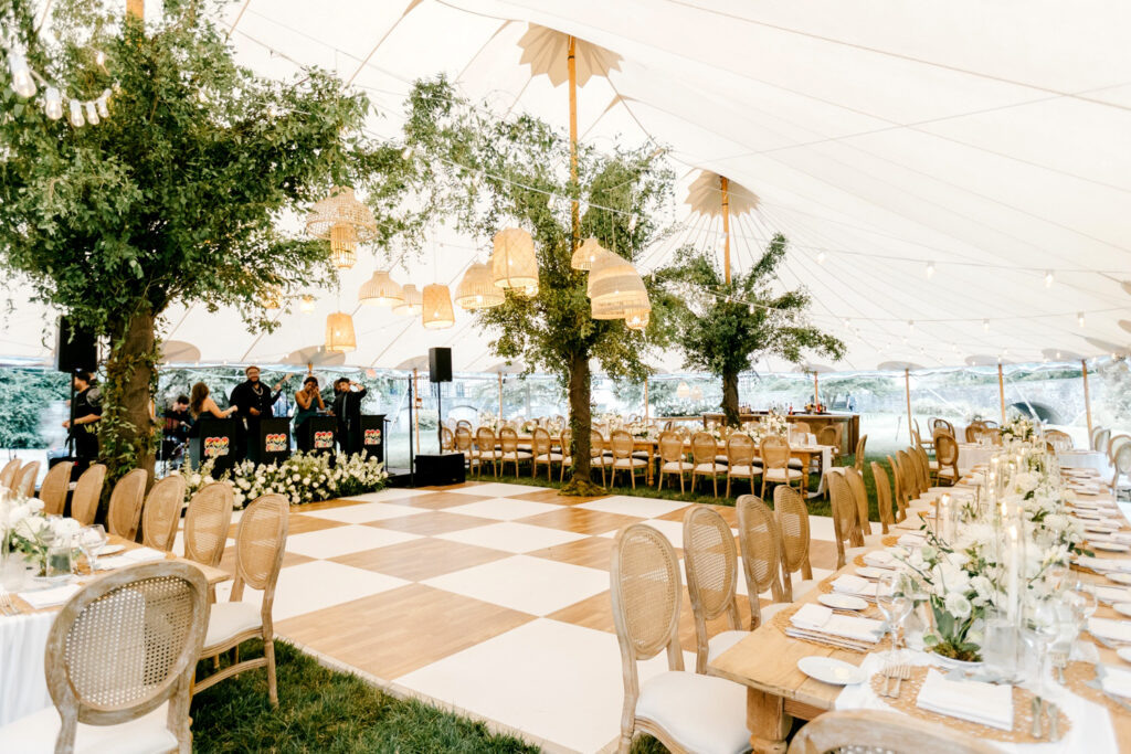 white and wood checkered dance floor for tented wedding reception