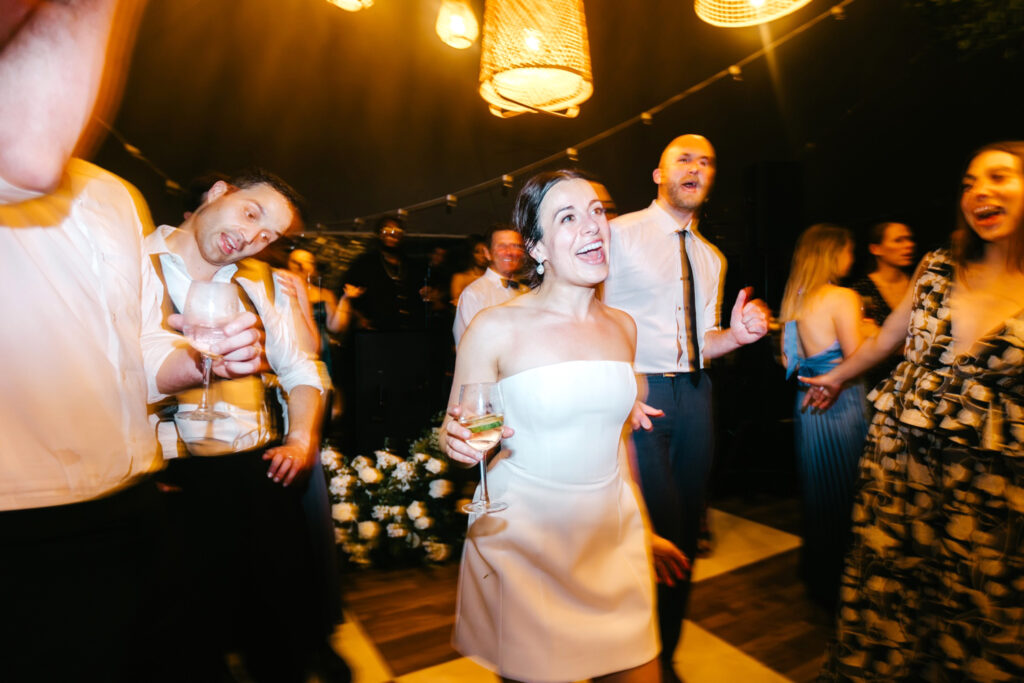 bride having fun at her summer Delaware wedding reception by Emily Wren Photography