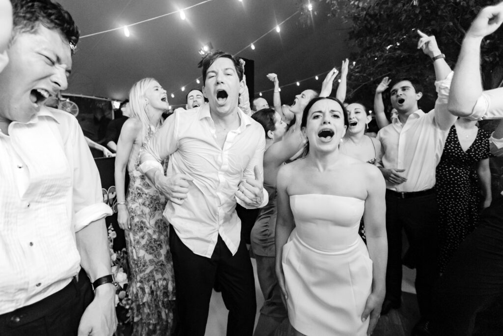 bride & groom having fun and dancing around at their Winterthur Museum wedding reception in Delaware