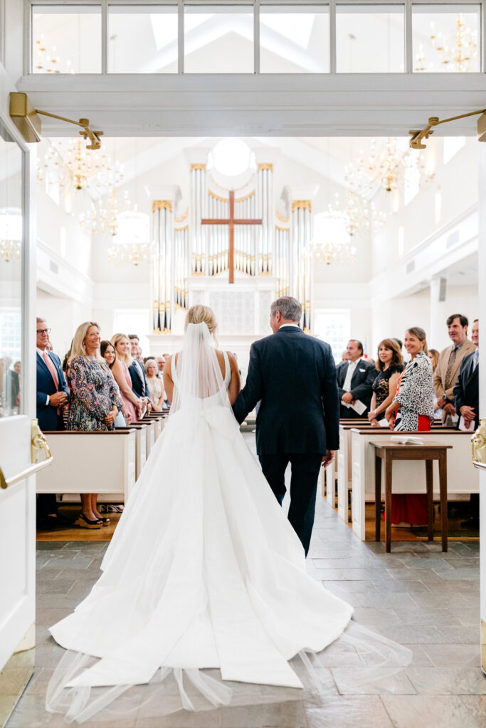 bride walking down the aisle at St Davids Episcopal Church by Emily Wren Photography