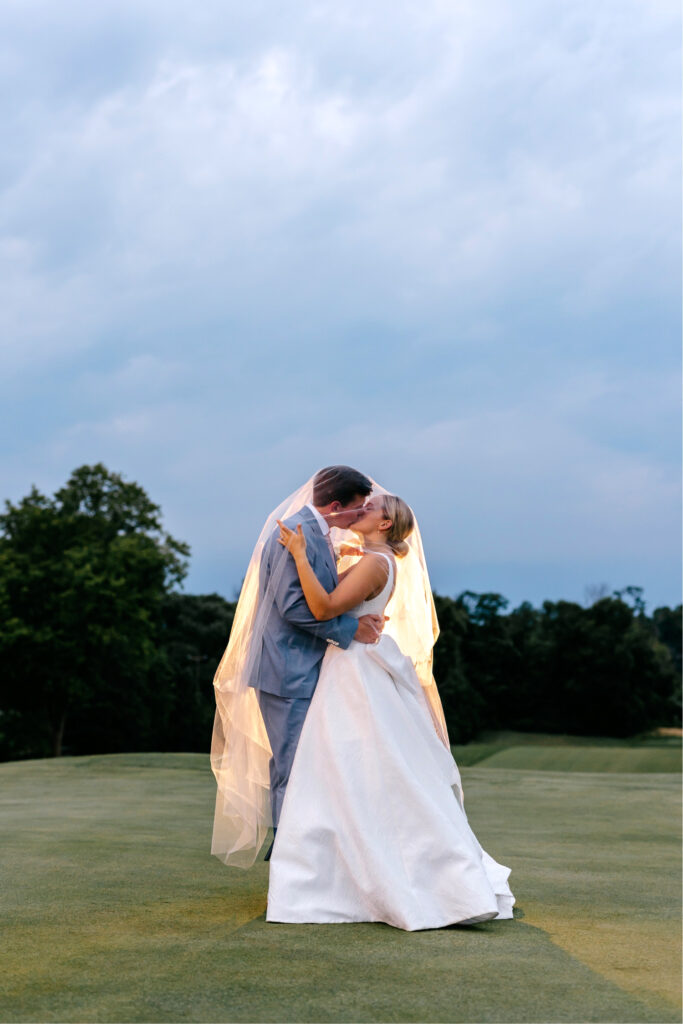 bride & groom kissing under the veil at night in Philadelphia