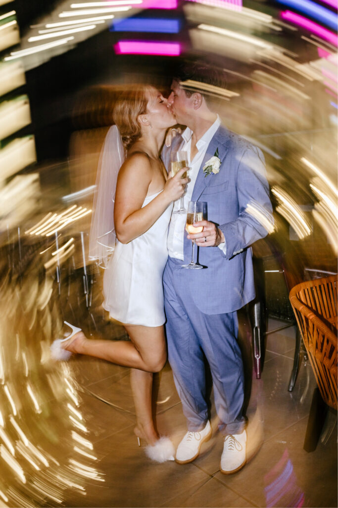 bride & groom kissing on balcony at Philadelphia wedding reception