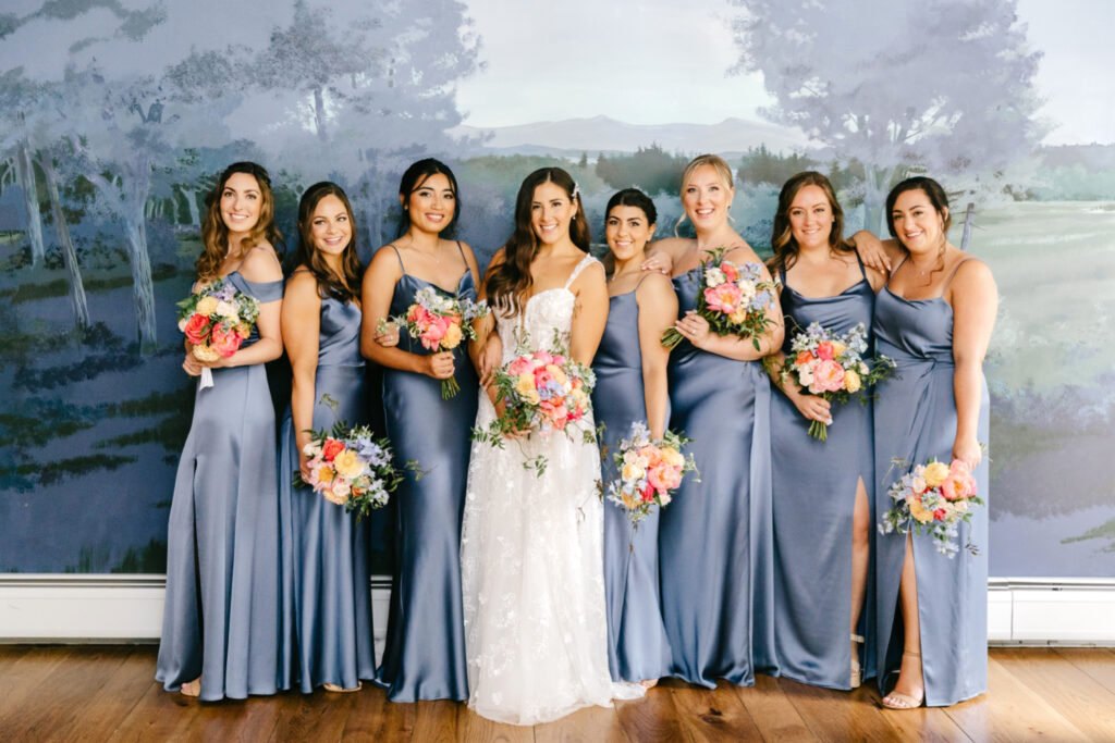 bride with bridesmaids in muted blue bridesmaid dresses