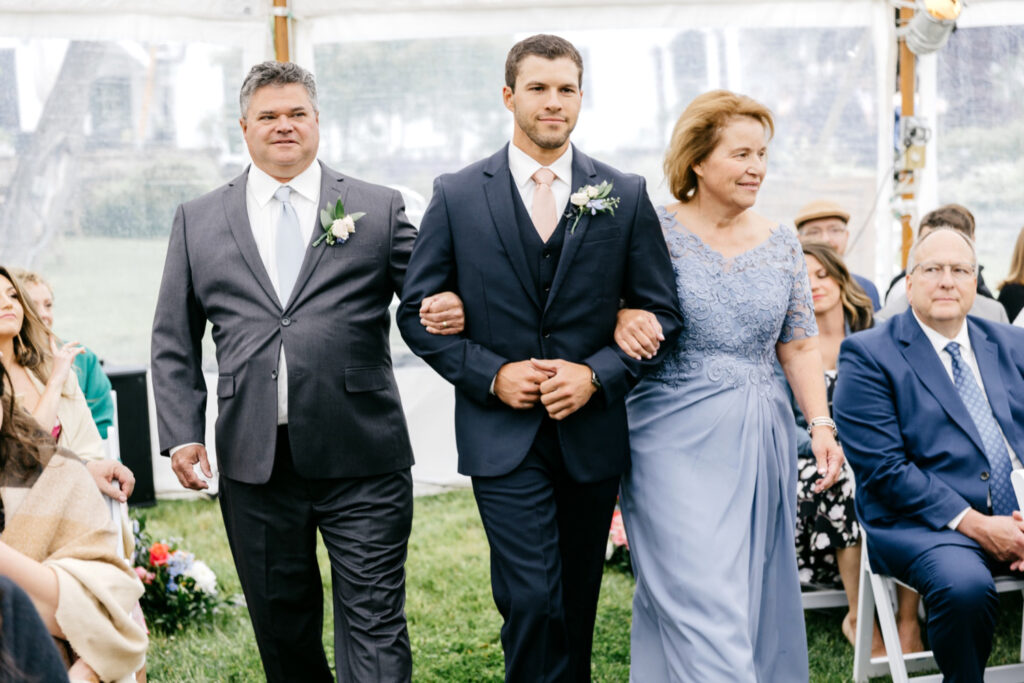 groom walking down the aisle at outdoor wedding ceremony at The Hermitage Inn