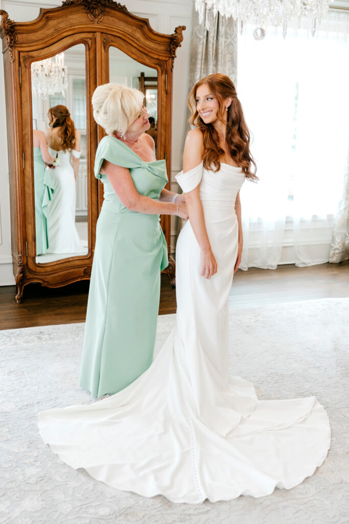 bride getting ready for her summer wedding day with her mother by Emily Wren Photography