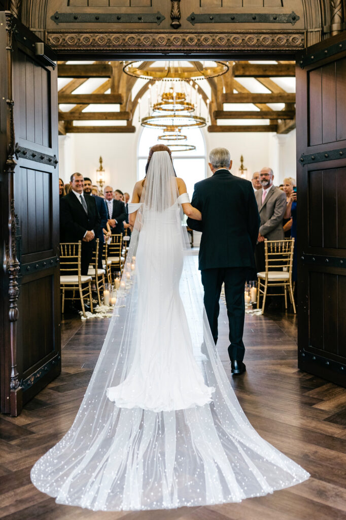 bride walking down the aisle at New Jersey estate chapel by Emily Wren Photography