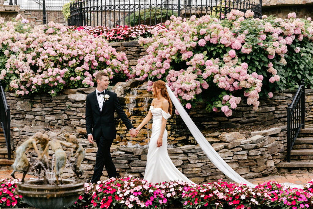 bride & groom in Park Savoy's pink floral gardens by Emily Wren Photography