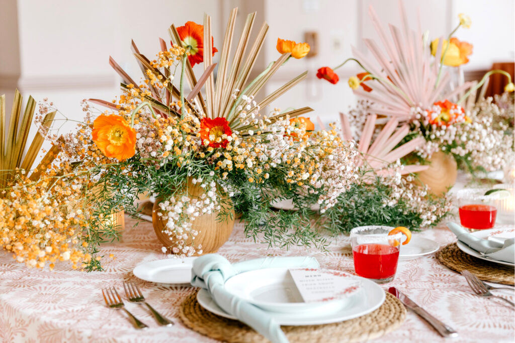 vibrant orange, red and blue wedding reception table decor for colorful bohemian spring wedding