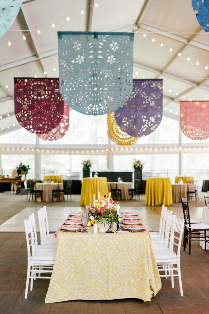 intimate bohemian wedding reception at The Orangery by Tyler Gardens featuring papel picado by Karina Puente