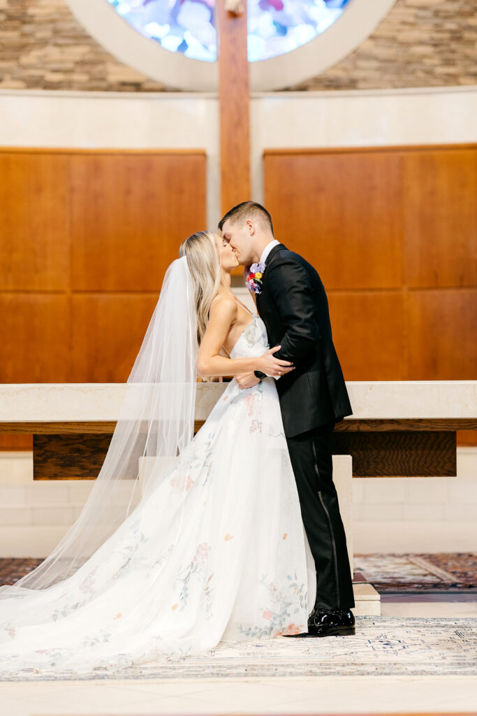 bride & groom's first kiss at church wedding ceremony at Saint Elizabeth's Parish in Pennsylvania by Emily Wren Photography