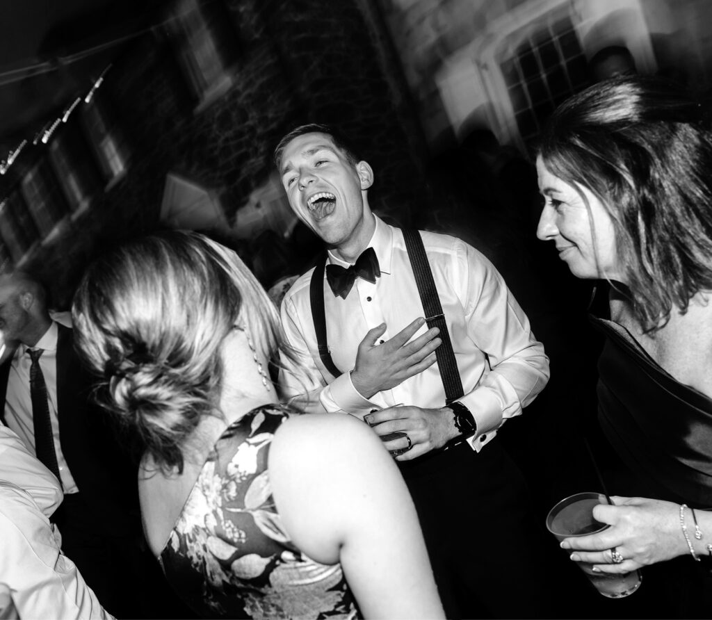 groom having fun at his late summer Pennsylvania wedding reception by Emily Wren Photography