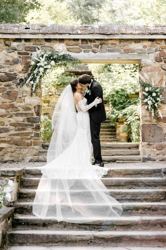 bride and grooms first kiss during outdoor Parque Ridley Creek wedding ceremony.