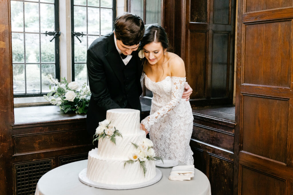 bride & groom cutting their 3 tier wedding cake at Ridley Creek wedding ceremony by Emily Wren Photography