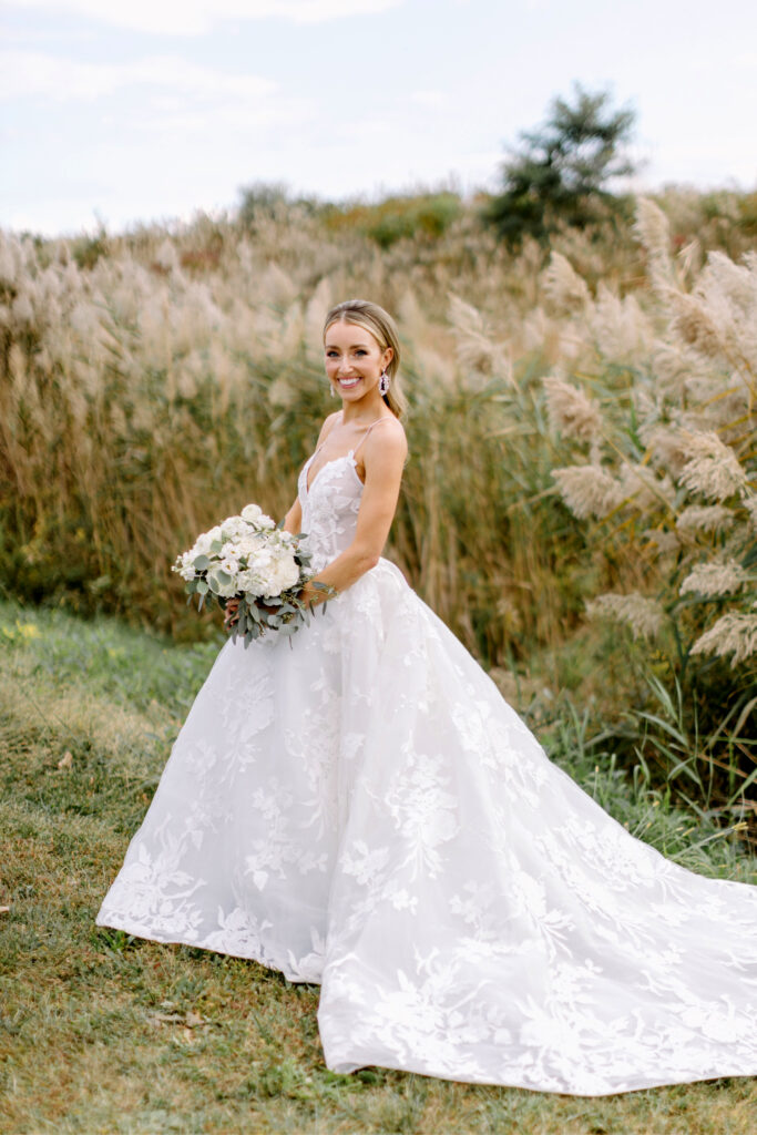 bridal portrait in field with fall foliage by Emily Wren Photography