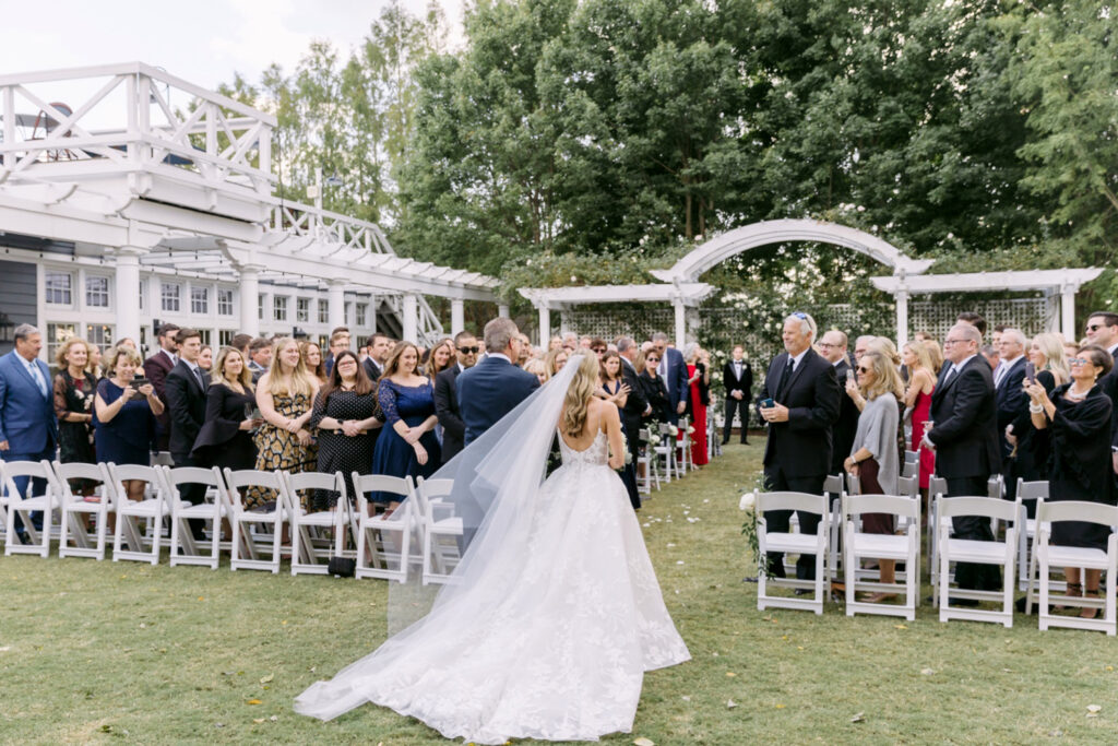 bride walking down the aisle at her outdoor Chesapeake Bay Beach Club wedding ceremony