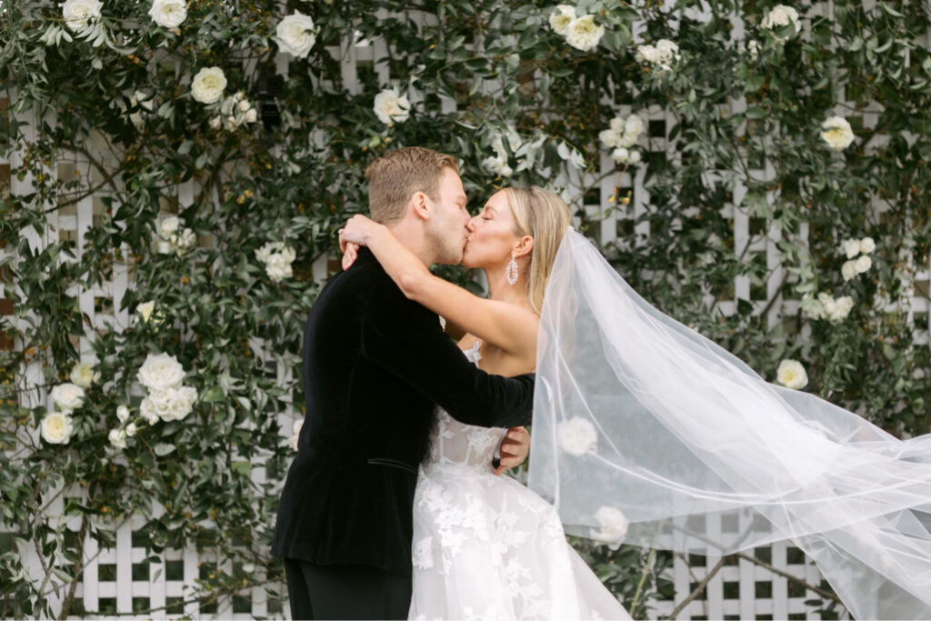 bride & grooms first kiss at Chesapeake Bay Beach Club wedding ceremony by elegant wedding photographer Emily Wren Photography