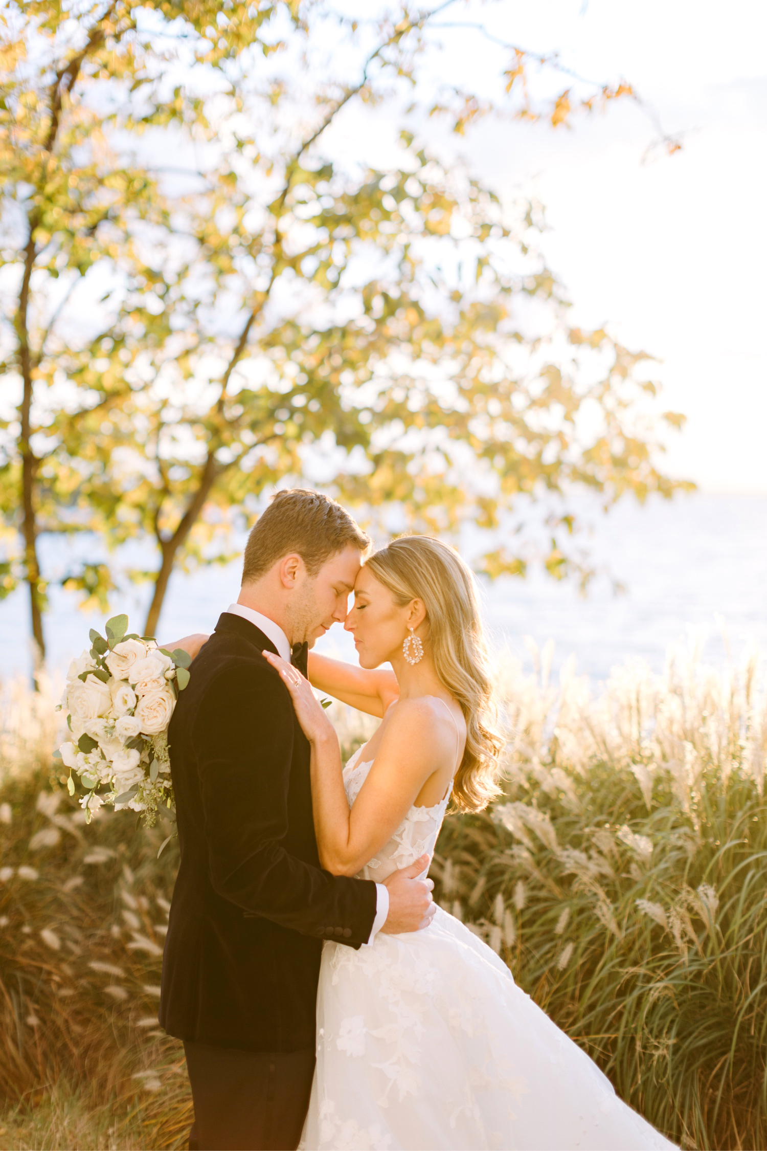 golden hour portrait of bride & groom on their fall wedding day ont he Chesapeake Bay beach shoreline