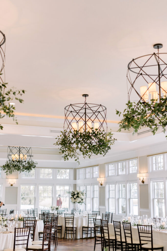 hanging chandeliers with greenery at elegant wedding reception