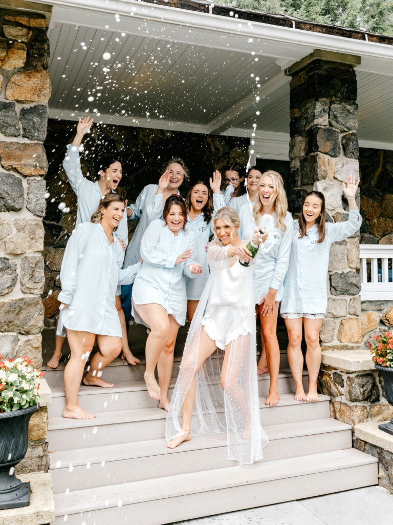 bride popping champagne before her summer wedding day in New Jersey