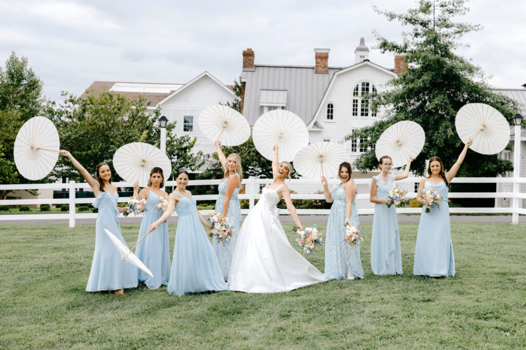 bride with bridesmaids holding white umbrellas on New Jersey summer wedding day