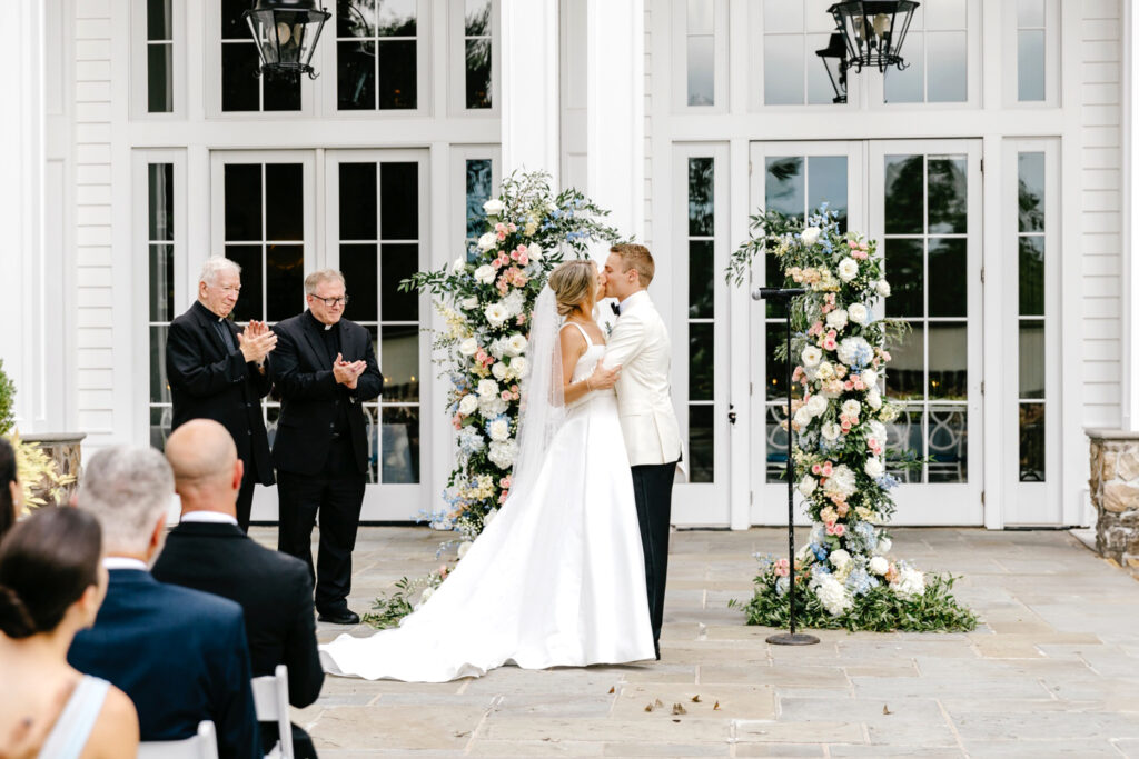 bride & grooms first kiss at their Ryland Inn outdoor wedding ceremony by Emily Wren Photography