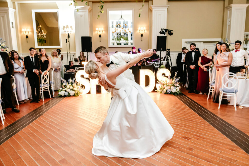 bride and grooms first dance at the Ryland Inn summer wedding reception in front of marquee letters