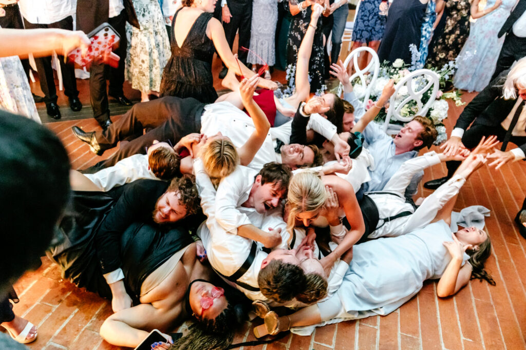 human dog pile at fun wedding reception at The Ryland Inn by Emily Wren Photography