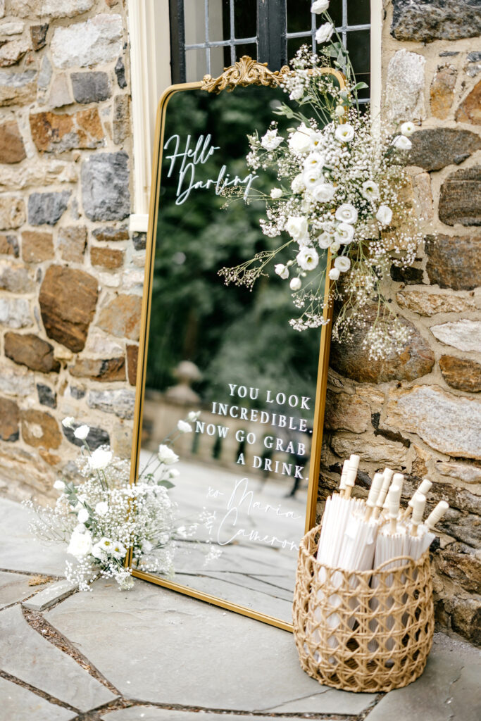 Golden arch wedding welcome mirror by Emily Wren Photography