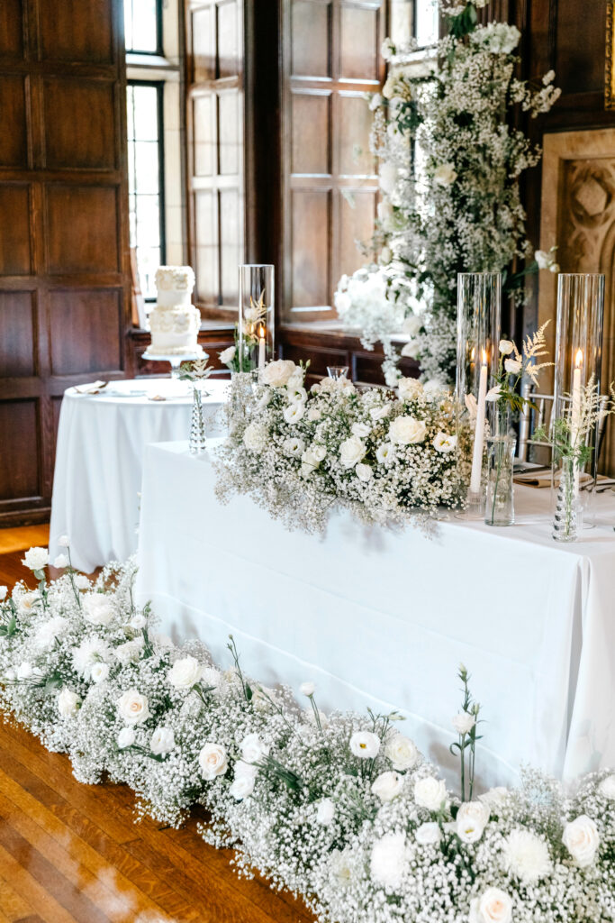 sweethearts table decorated with white roses & babies breath at Parque Ridley Creek wedding reception