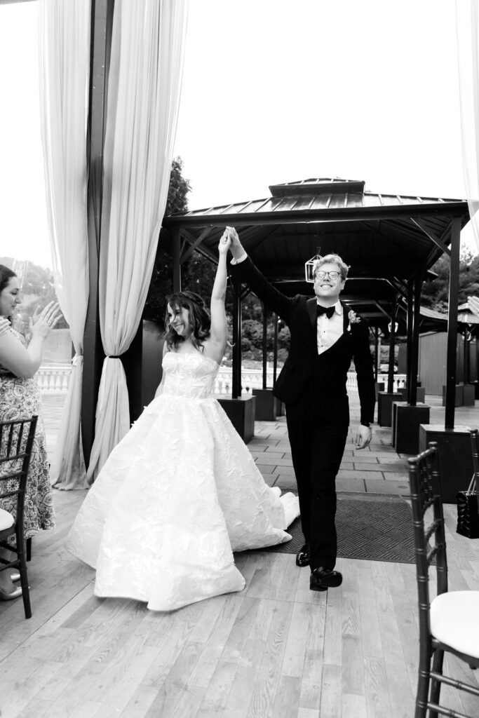 bride & groom entering Cescaphe wedding reception at Water Works by luxury Philadelphia wedding photographer Emily Wren Photography