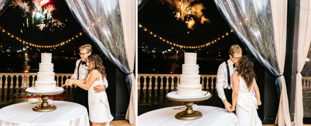 bride & groom cutting their wedding cake at their Cescaphe Wedding reception as fireworks go off over the river by Emily Wren Photography