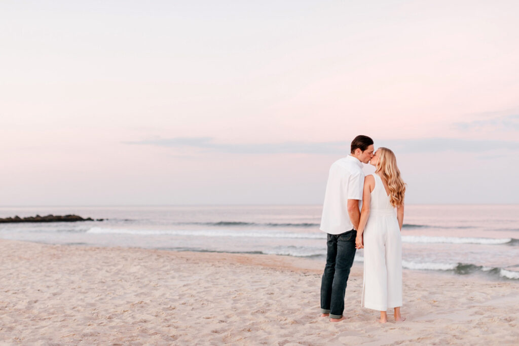 engagement photos on the beach with pink sunset in Spring Lake New Jersey by Emily Wren Photography